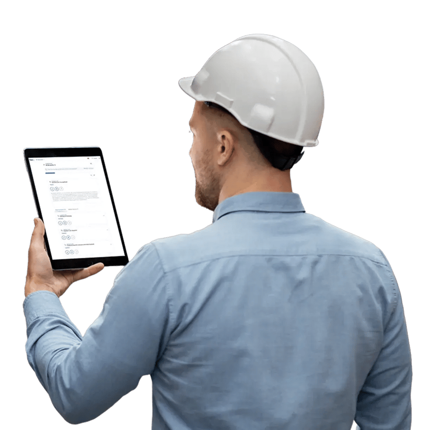 A worker wearing a white hardhat and a light blue shirt looks at a tablet that displays the findIQ app.