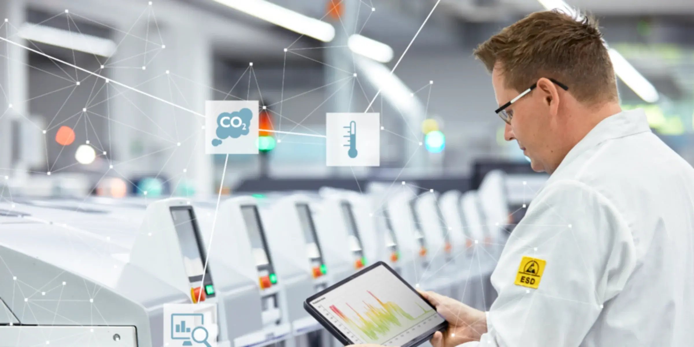 Scientific employee in front of a row of machines